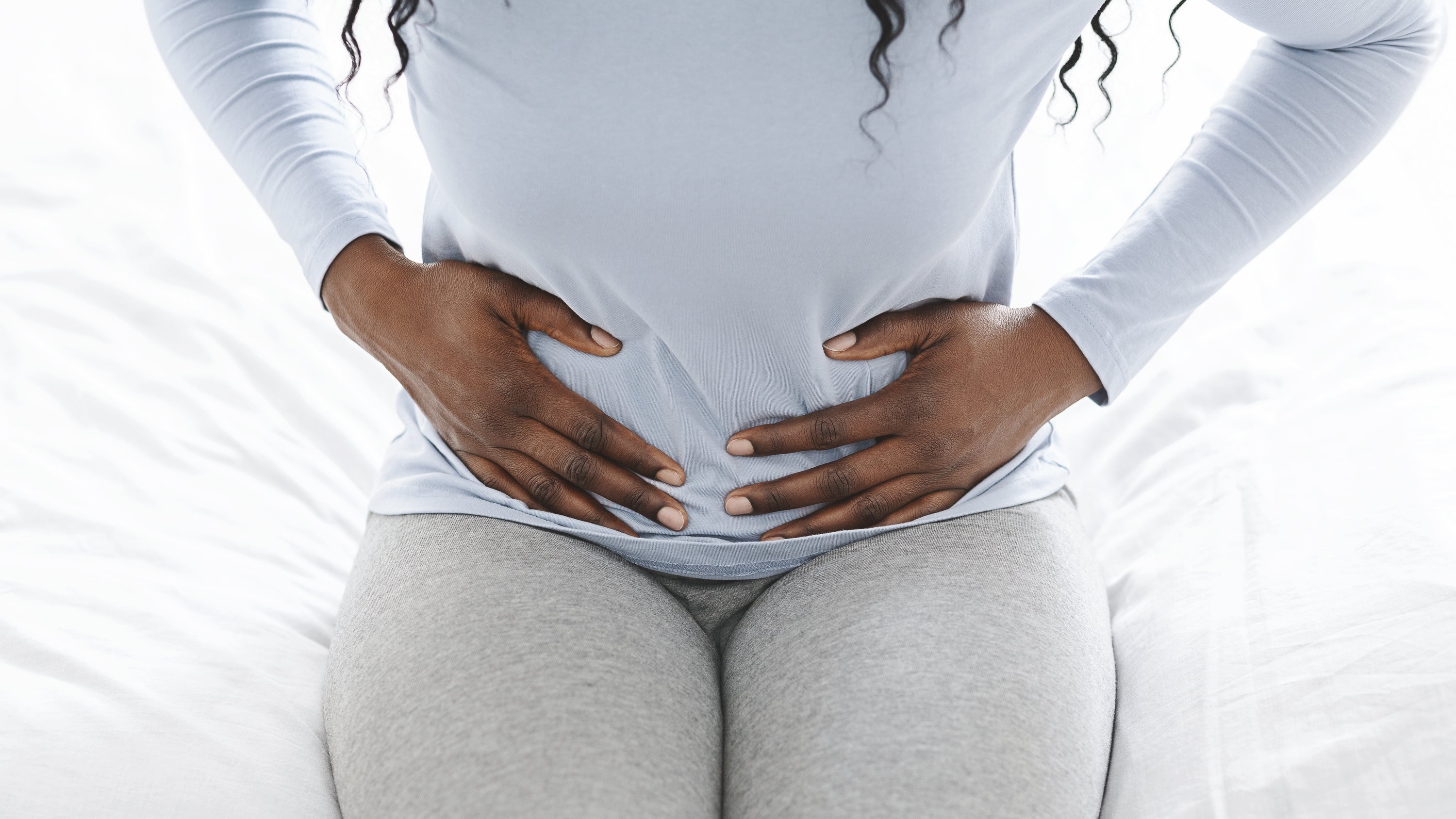 Person holding her belly 